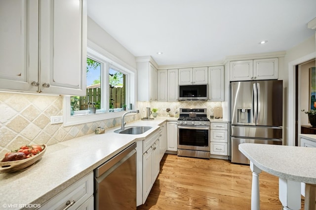 1728 Wildberry Dr Unit B, Glenview, IL 60025 - kitchen with stainless steel appliances, light wood finished floors, light countertops, white cabinetry, and recessed lighting