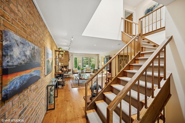 1728 Wildberry Dr Unit B, Glenview, IL 60025 - staircase featuring wood finished floors, brick wall, and a brick fireplace