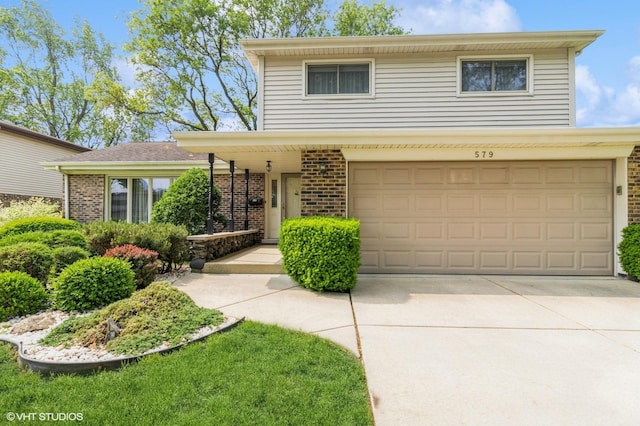 579 Figard Ln, Des Plaines, IL 60016 - view of front of house featuring brick siding, concrete driveway, and an attached garage