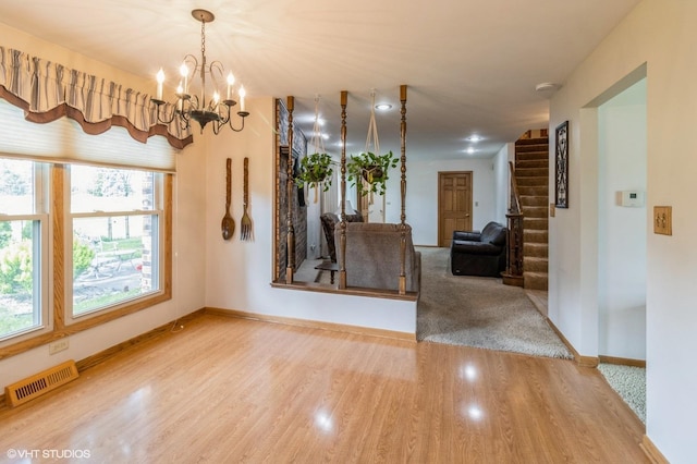 579 Figard Ln, Des Plaines, IL 60016 - unfurnished dining area featuring wood finished floors, a chandelier, and stairs