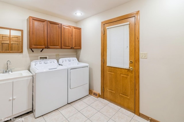 579 Figard Ln, Des Plaines, IL 60016 - laundry area with washer and dryer, cabinet space, and light tile patterned floors