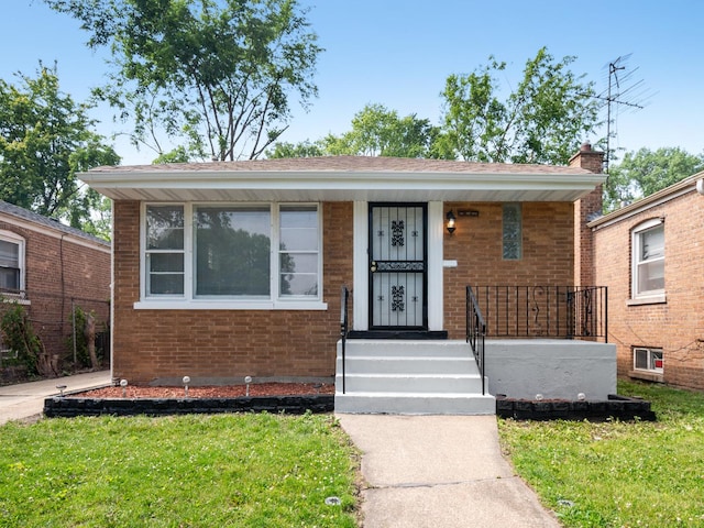 142 W Brayton St, Chicago, IL 60628 - bungalow-style home featuring brick siding, a porch, and a front yard