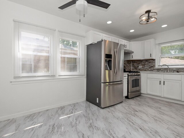 142 W Brayton St, Chicago, IL 60628 - kitchen with appliances with stainless steel finishes, white cabinetry, a ceiling fan, decorative backsplash, and a sink