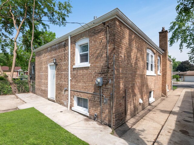 142 W Brayton St, Chicago, IL 60628 - back of house with brick siding and a chimney