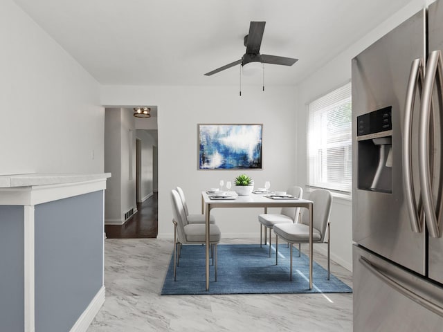 142 W Brayton St, Chicago, IL 60628 - dining area featuring a ceiling fan, light marble finish floors, and baseboards