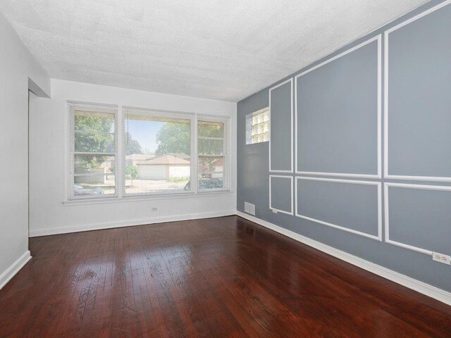 142 W Brayton St, Chicago, IL 60628 - spare room with wood finished floors, baseboards, and a textured ceiling