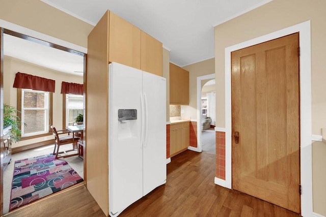 3235 Cuyler Ave, Berwyn, IL 60402 - kitchen featuring white fridge with ice dispenser, dark wood finished floors, crown molding, and arched walkways