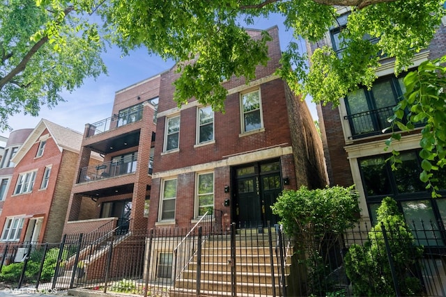1020 N Wood St, Chicago, IL 60622 - view of front of property with brick siding and a fenced front yard