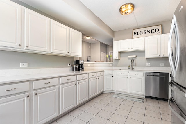 390 W Mahogany Ct Unit 301, Palatine, IL 60067 - kitchen featuring appliances with stainless steel finishes, a sink, light tile patterned floors, white cabinets, and light countertops
