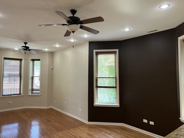 5722 S Aberdeen St, Chicago, IL 60621 - empty room with wood finished floors, plenty of natural light, ceiling fan, and recessed lighting