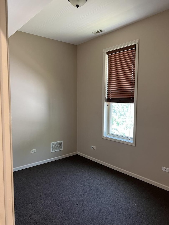 5722 S Aberdeen St, Chicago, IL 60621 - spare room with dark colored carpet and baseboards