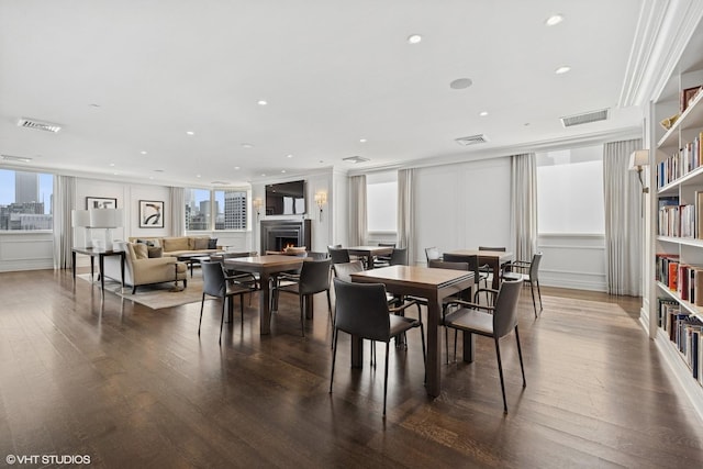 990 N Lake Shore Dr Unit 10A, Chicago, IL 60611 - dining room with a warm lit fireplace, wood finished floors, and recessed lighting
