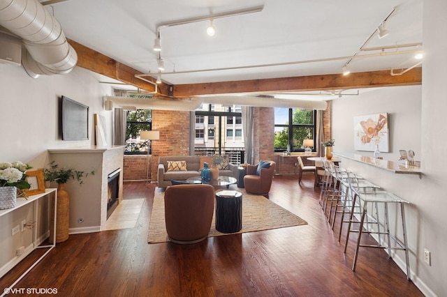 520 W Huron St Unit 220, Chicago, IL 60654 - living area with track lighting, wood finished floors, a fireplace with flush hearth, and beamed ceiling