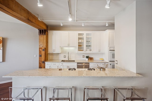 520 W Huron St Unit 220, Chicago, IL 60654 - kitchen with dishwasher, glass insert cabinets, light stone counters, and white cabinets