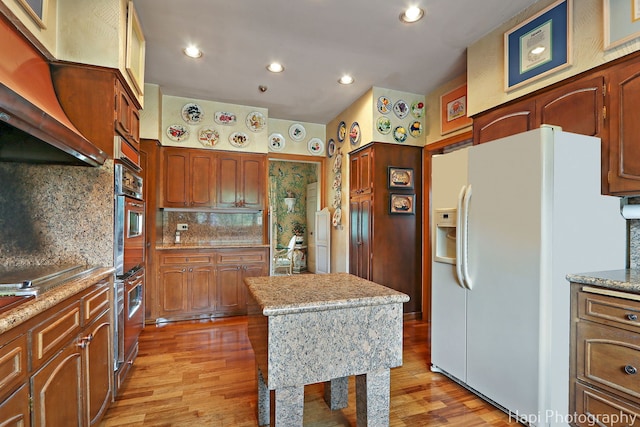 7 3 Lakes Rd, Barrington Hills, IL 60010 - kitchen featuring white fridge with ice dispenser, light wood-style floors, backsplash, recessed lighting, and stainless steel double oven