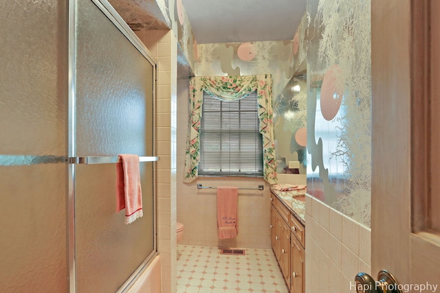 7 3 Lakes Rd, Barrington Hills, IL 60010 - bathroom with vanity, tile walls, tile patterned floors, and enclosed tub / shower combo