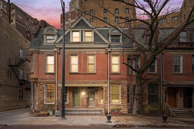 2113 N Clark St, Chicago, IL 60614 - view of property with brick siding, roof with shingles, and mansard roof