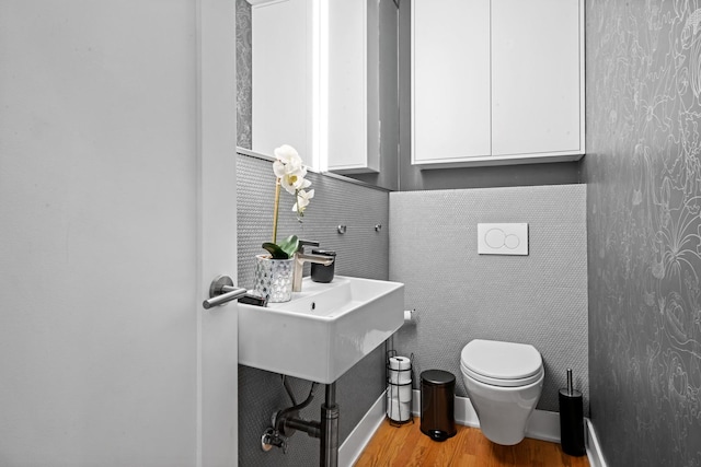 2113 N Clark St, Chicago, IL 60614 - half bathroom with toilet, wood finished floors, and a sink