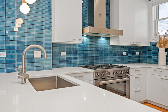 2113 N Clark St, Chicago, IL 60614 - kitchen with island exhaust hood, stainless steel gas range oven, a sink, and white cabinets