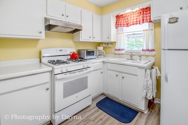 527 Edwin Dr, Bourbonnais, IL 60914 - kitchen with white appliances, under cabinet range hood, white cabinets, light wood finished floors, and light countertops