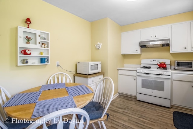 527 Edwin Dr, Bourbonnais, IL 60914 - kitchen featuring white appliances, under cabinet range hood, white cabinetry, wood finished floors, and light countertops