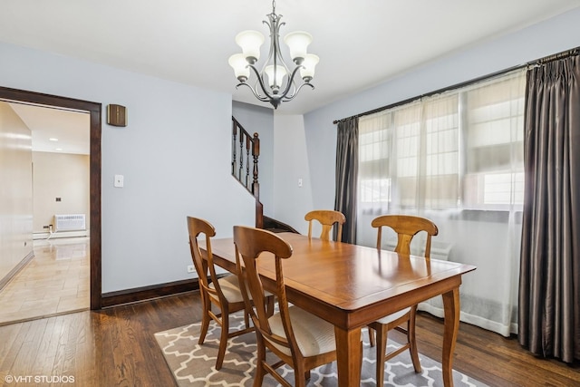 7229 W Lunt Ave, Chicago, IL 60631 - dining space with a chandelier, wood finished floors, stairs, and an AC wall unit