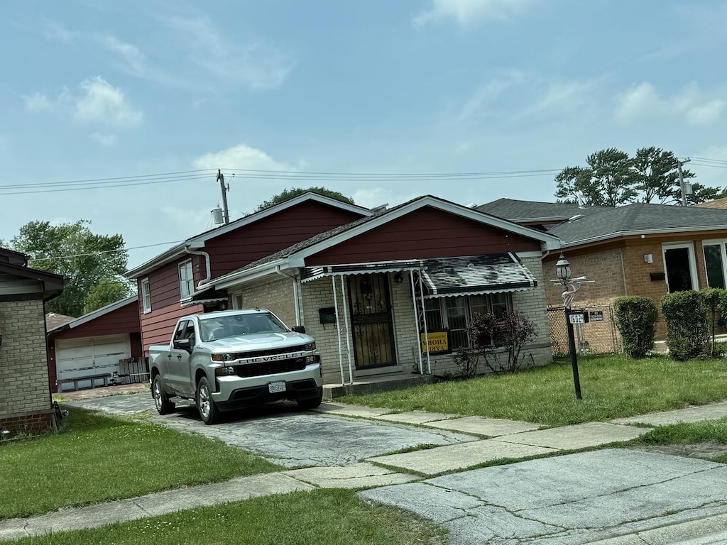 16024 Myrtle Ave, Harvey, IL 60426 - bungalow-style home featuring brick siding, a front yard, and asphalt driveway