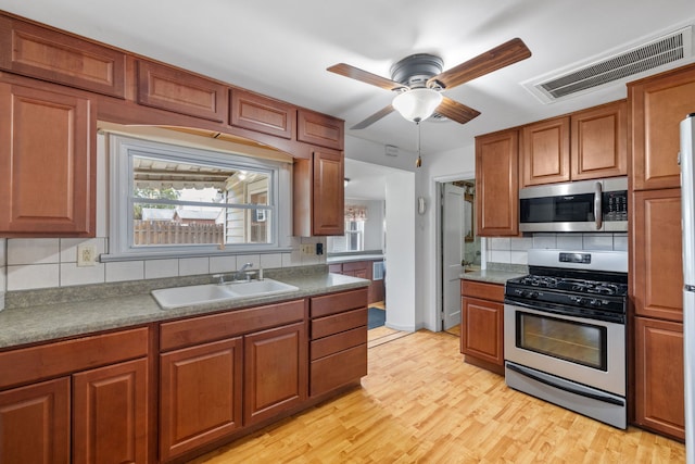 1811 Dearborn St, Crest Hill, IL 60403 - kitchen with stainless steel appliances, decorative backsplash, brown cabinets, and ceiling fan