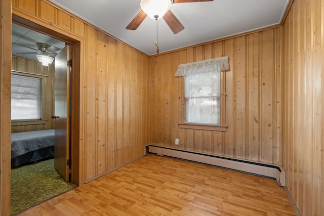 1811 Dearborn St, Crest Hill, IL 60403 - unfurnished room featuring a baseboard radiator, ceiling fan, light wood-type flooring, and wood walls