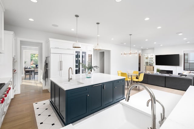 834 Wellner Rd, Naperville, IL 60540 - kitchen featuring white cabinetry, recessed lighting, light wood-style flooring, hanging light fixtures, and paneled built in refrigerator