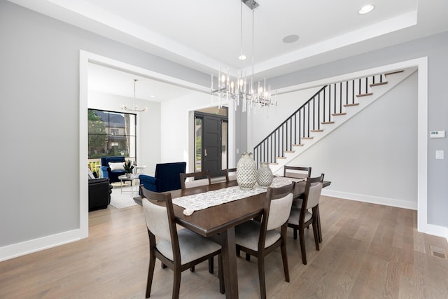 834 Wellner Rd, Naperville, IL 60540 - dining area featuring a chandelier, wood finished floors, stairway, a raised ceiling, and recessed lighting