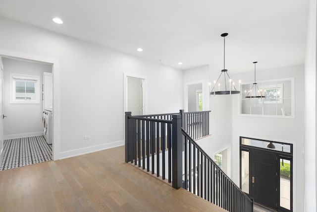 834 Wellner Rd, Naperville, IL 60540 - hall with an upstairs landing, washer / clothes dryer, a chandelier, wood finished floors, and recessed lighting