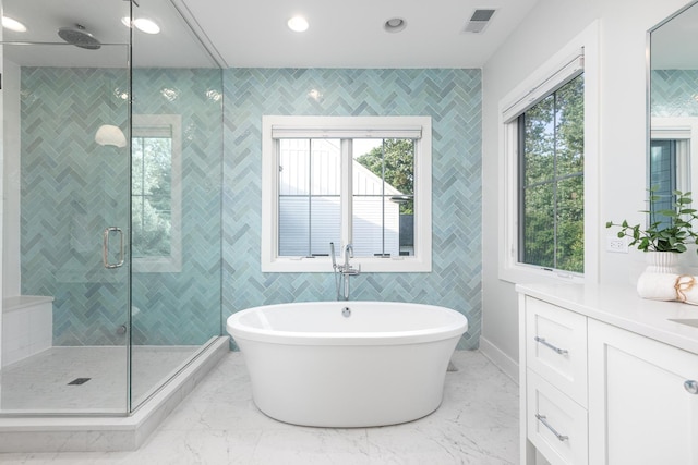 834 Wellner Rd, Naperville, IL 60540 - bathroom featuring tile walls, a freestanding bath, a shower stall, vanity, and marble finish flooring