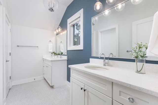 834 Wellner Rd, Naperville, IL 60540 - bathroom featuring two vanities, lofted ceiling, and tile patterned flooring