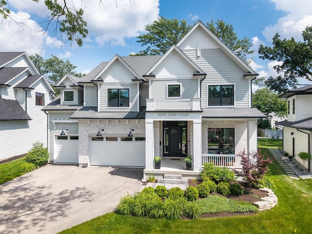 834 Wellner Rd, Naperville, IL 60540 - view of front facade featuring covered porch, asphalt driveway, an attached garage, roof with shingles, and a front yard