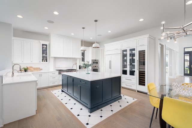 834 Wellner Rd, Naperville, IL 60540 - kitchen featuring white cabinetry, light countertops, light wood finished floors, and recessed lighting