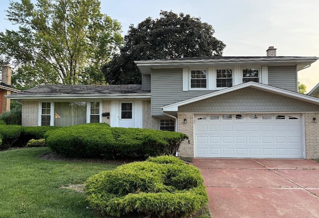907 E Crabtree Dr, Arlington Heights, IL 60004 - tri-level home with a chimney, an attached garage, concrete driveway, and brick siding