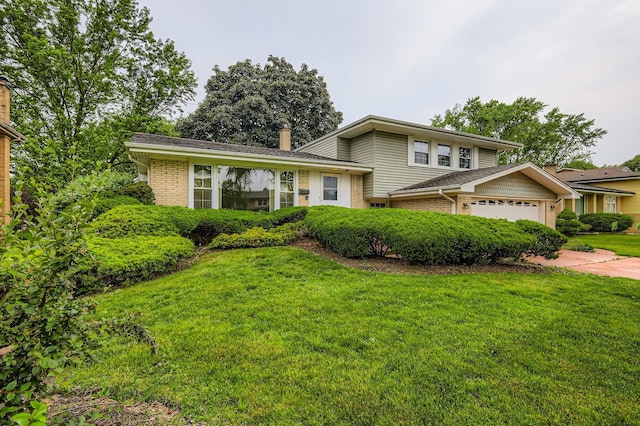 907 E Crabtree Dr, Arlington Heights, IL 60004 - tri-level home with brick siding, a front yard, a chimney, driveway, and a garage