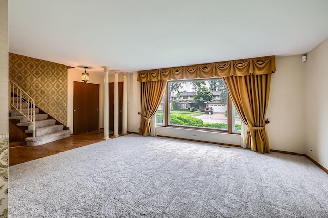 907 E Crabtree Dr, Arlington Heights, IL 60004 - unfurnished living room with wallpapered walls, carpet, decorative columns, and stairs