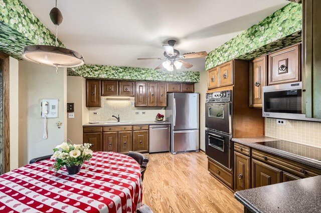907 E Crabtree Dr, Arlington Heights, IL 60004 - kitchen with black appliances, backsplash, a ceiling fan, light wood-style floors, and dark countertops