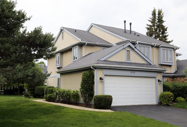 402 Catbird Ln, Deerfield, IL 60015 - view of front facade with asphalt driveway, a front yard, and a garage