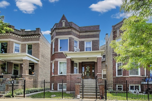 3425 W Lyndale St, Chicago, IL 60647 - view of front of house featuring brick siding, a fenced front yard, and cooling unit