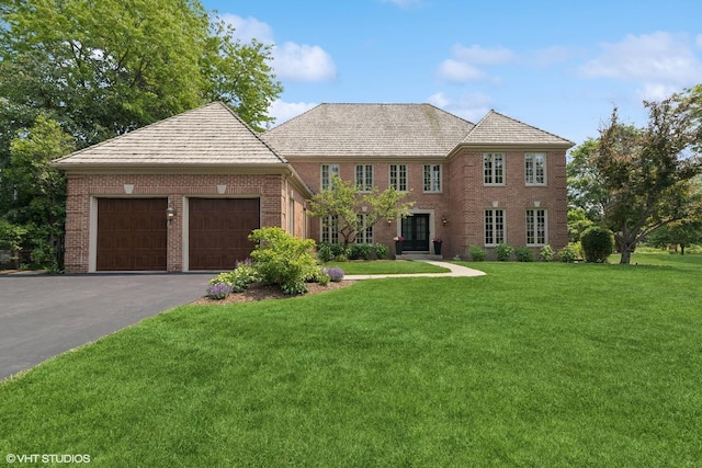 31 E Sandpiper Ln, Lake Forest, IL 60045 - colonial house featuring a garage, a front lawn, brick siding, asphalt driveway, and french doors
