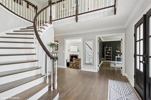 31 E Sandpiper Ln, Lake Forest, IL 60045 - entryway with stairs, wood finished floors, crown molding, a fireplace, and french doors