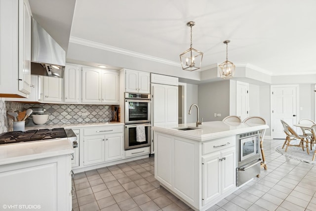 31 E Sandpiper Ln, Lake Forest, IL 60045 - kitchen with stainless steel appliances, light countertops, wall chimney exhaust hood, tasteful backsplash, and a warming drawer