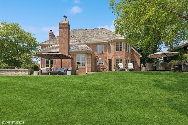 31 E Sandpiper Ln, Lake Forest, IL 60045 - rear view of house featuring outdoor lounge area, a chimney, brick siding, and a yard