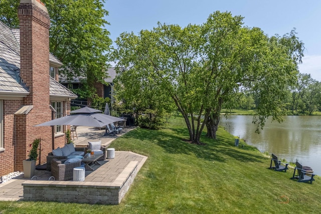 31 E Sandpiper Ln, Lake Forest, IL 60045 - view of green lawn with a water view and a patio area