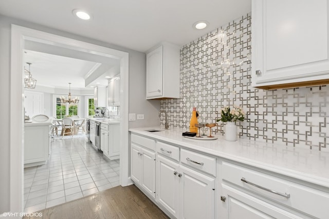 31 E Sandpiper Ln, Lake Forest, IL 60045 - kitchen featuring a chandelier, white cabinetry, decorative backsplash, light countertops, and recessed lighting