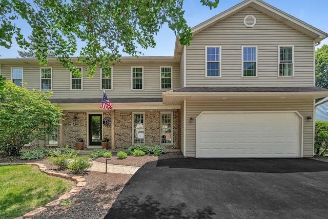 336 Brooklea Ct, Naperville, IL 60565 - view of front of home with an attached garage, asphalt driveway, and brick siding