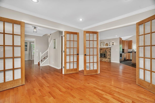 336 Brooklea Ct, Naperville, IL 60565 - empty room featuring french doors, light wood-type flooring, ornamental molding, recessed lighting, and a brick fireplace